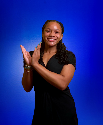 Studio portrait of Jasmine Jackson against a blue gradient background.